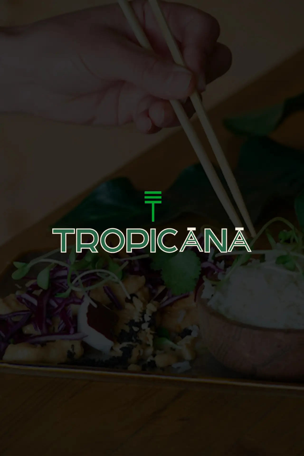 a person holding chopsticks over food